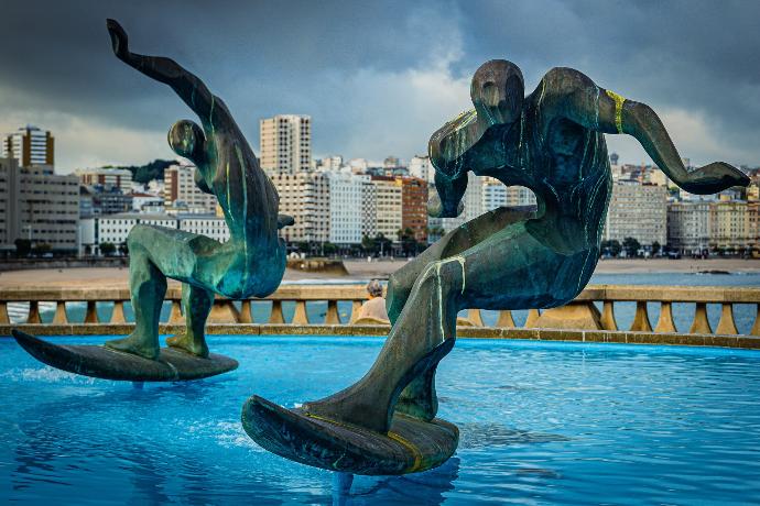 man in black suit statue near swimming pool during daytime